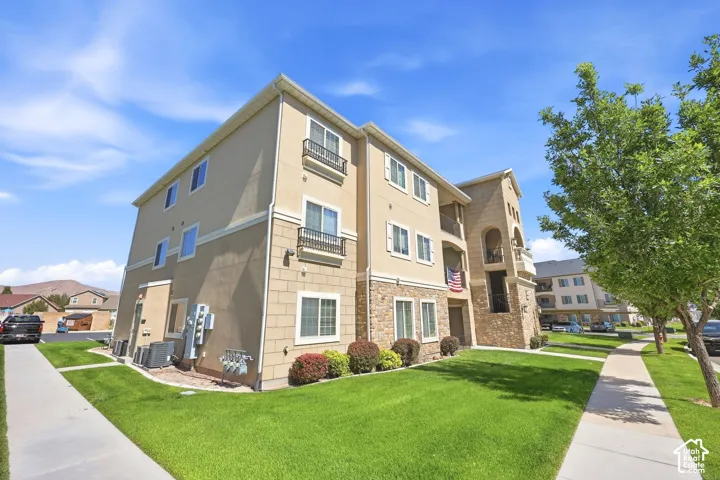 Multi-story building featuring a stucco and stone veneer exterior