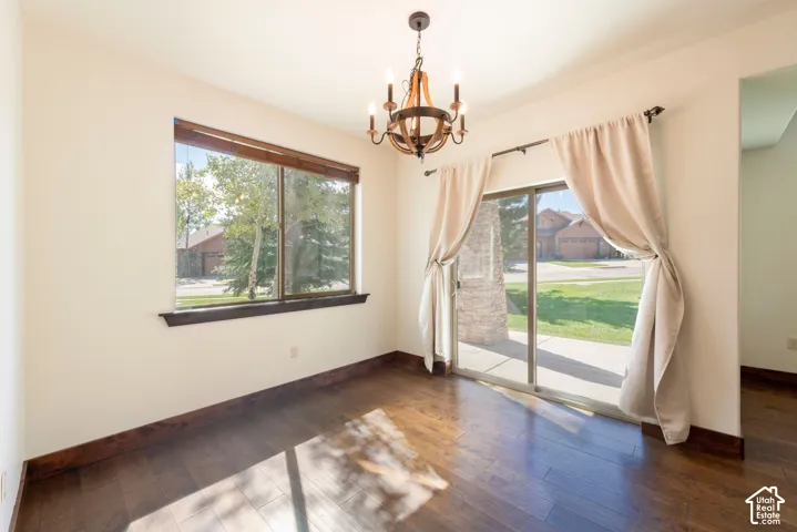 Dark wood-finish flooring with coordinating baseboards and window trim