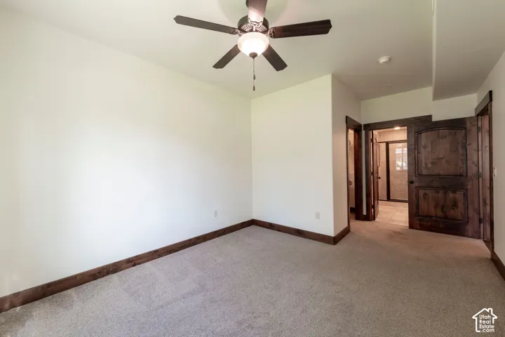 Carpeted flooring with wood trim and solid wood interior doors