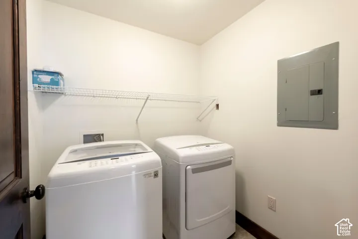 Dedicated laundry area featuring a wire shelving unit