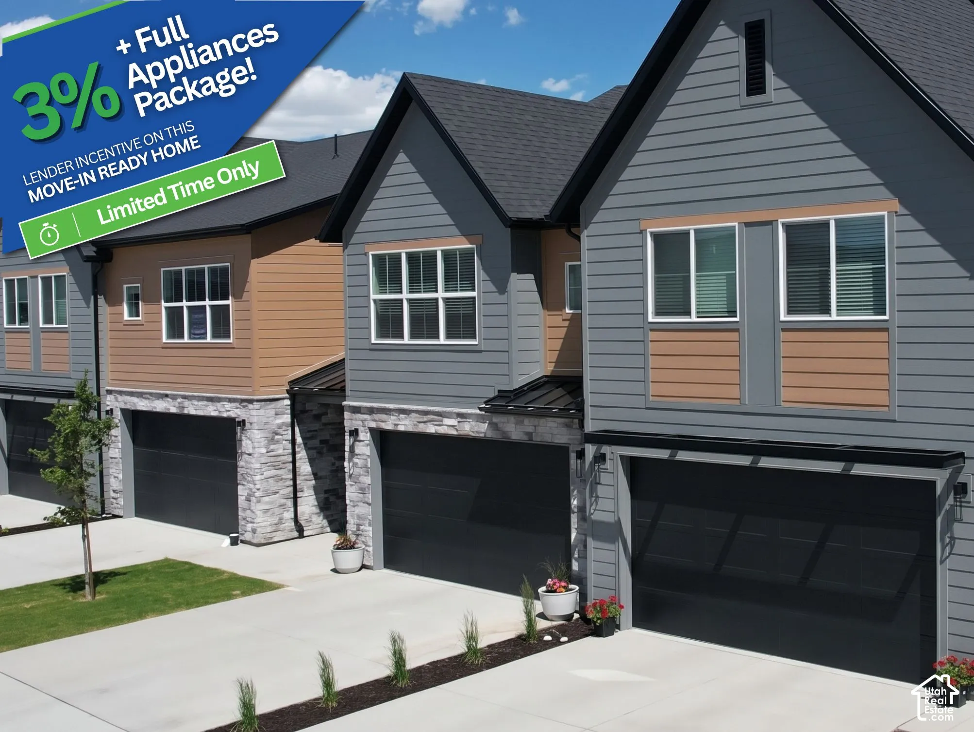 Multi-level exterior featuring horizontal lap siding, stacked stone accents, shingle roofing, and attached garage doors with concrete driveways