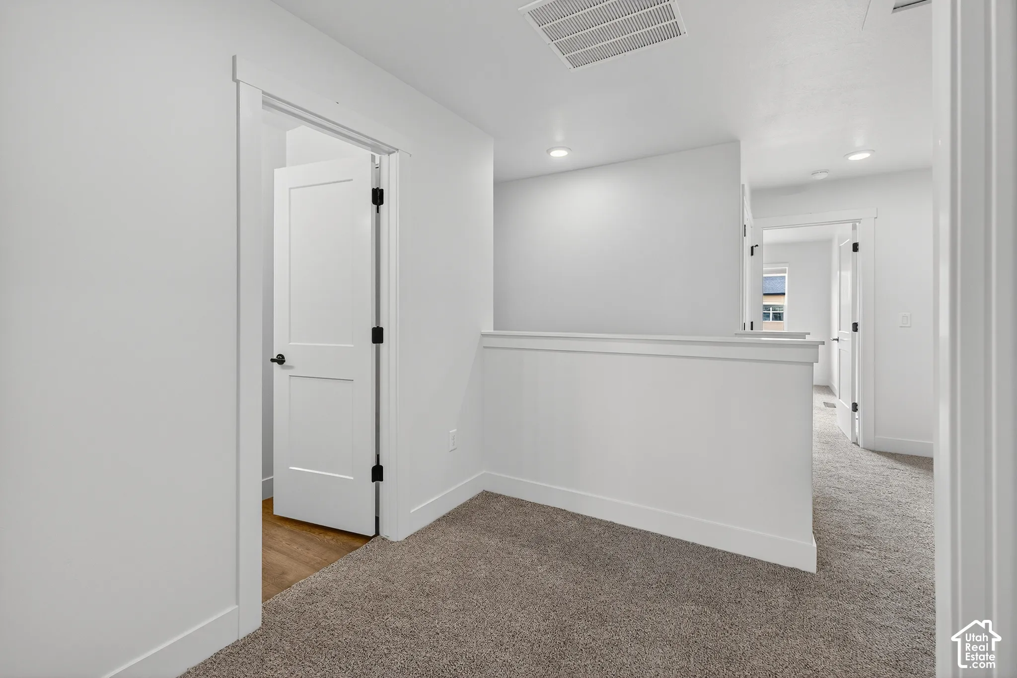 Bright interior with recessed lighting, carpet flooring, and white trim molding