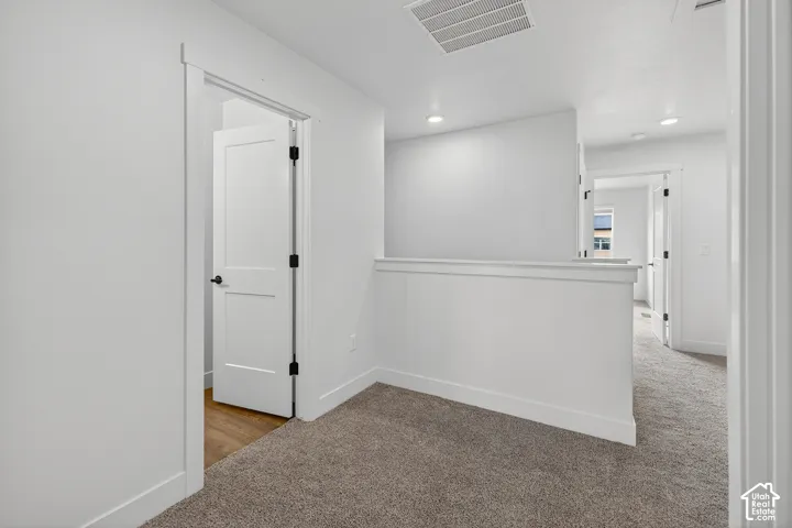 Bright interior with recessed lighting, carpet flooring, and white trim molding