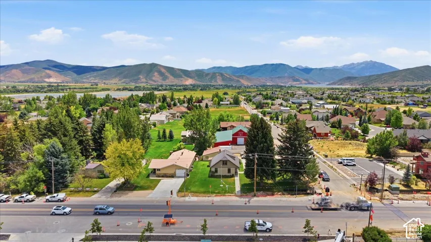 Neighborhood setting with surrounding mountain ranges and a verdant valley