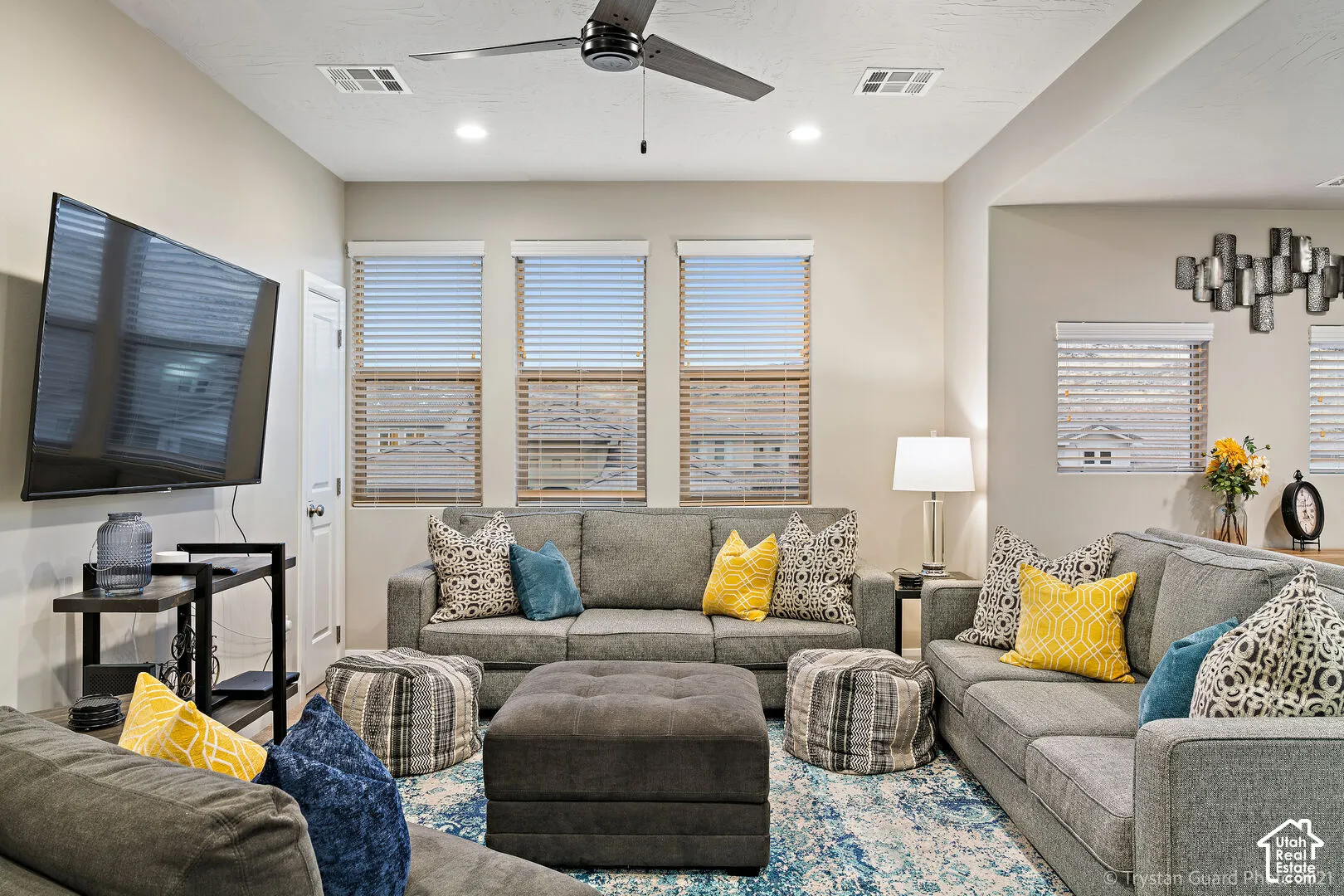 Recessed lighting, ceiling fan, and multiple windows with blinds