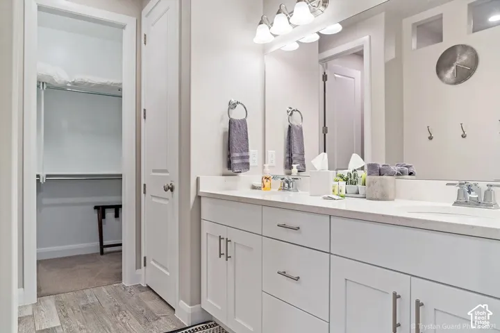 Dual vanity with a stone-finish countertop, undermount sinks, and chrome faucets