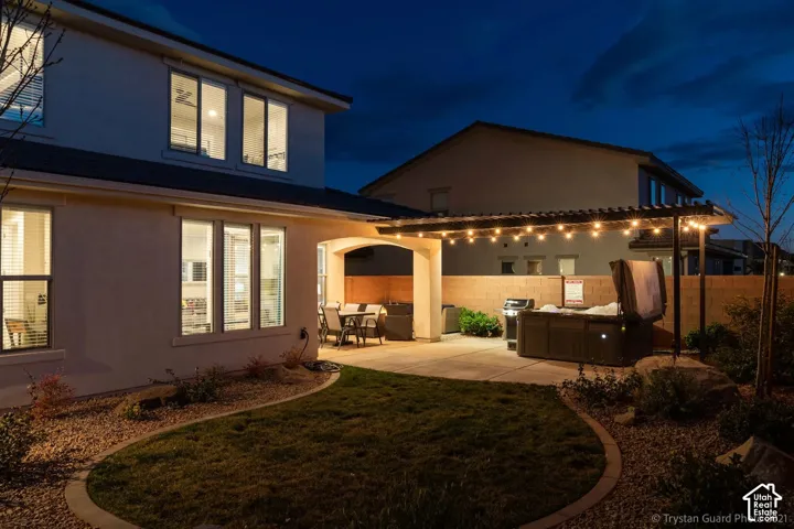 Expansive concrete patio with a permanent pergola structure
