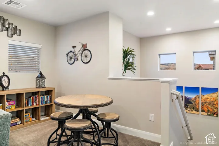 Recessed lighting, wood-finish shelving, and multiple windows