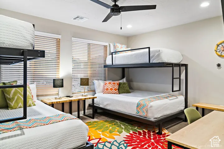 Room featuring two metal-frame bunk beds, a ceiling fan, recessed lighting, and dual windows with horizontal blinds