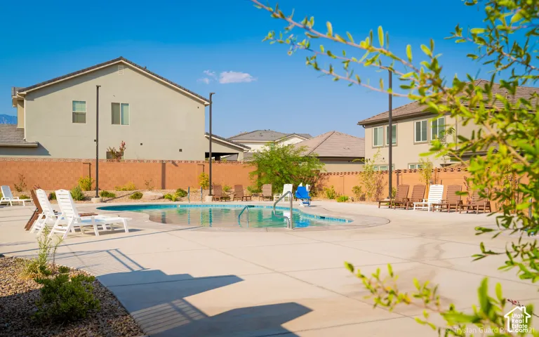 Outdoor swimming pool with integrated spa and concrete decking
