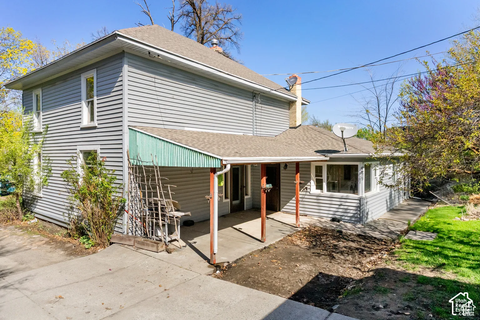 Two-story residence with horizontal vinyl siding and composite roofing