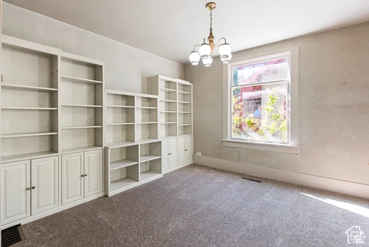 Built-in white cabinetry, integrated shelving, and a large window with white trim