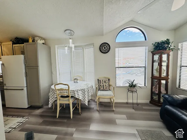Wood-finish flooring throughout, vaulted ceiling, and an arched transom window