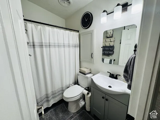 Vanity with undermount sink, dark bronze faucet, and gray cabinetry