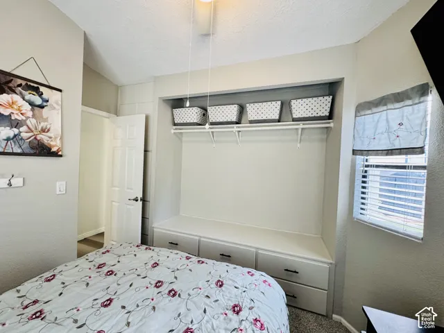 Built-in storage bench with three drawers, integrated shelving, and a ceiling fan