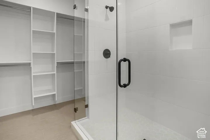 primary Walk-in shower with clear glass enclosure and matte black hardware