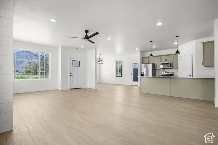 Granite Open-concept living space featuring light wood-finish flooring, recessed lighting, and a modern ceiling fan