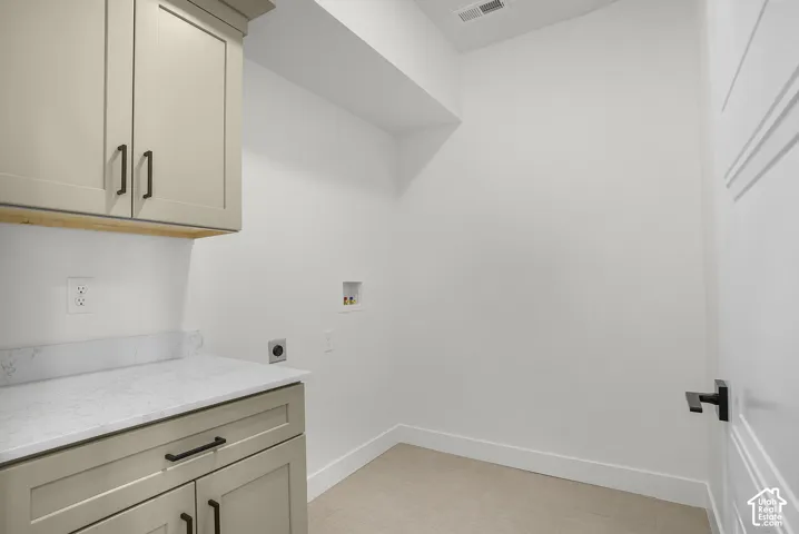 Shaker-style cabinetry with matte black hardware, white countertop, and clean white walls