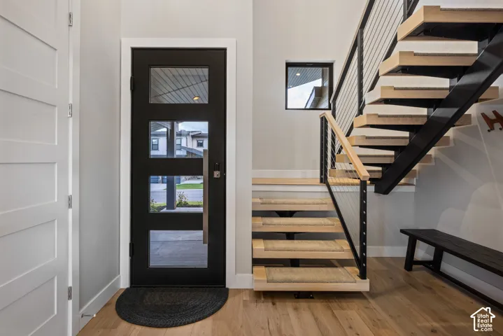 Modern open-riser staircase with wood treads and a cable railing system