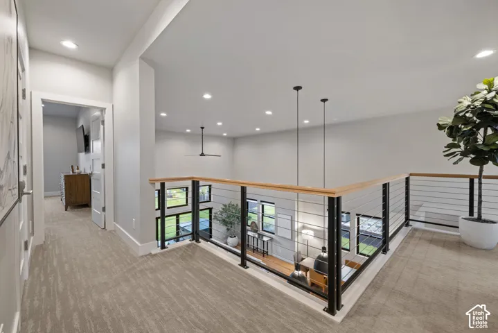 Open loft area featuring cable railing, wood handrails, recessed lighting, and a ceiling fan