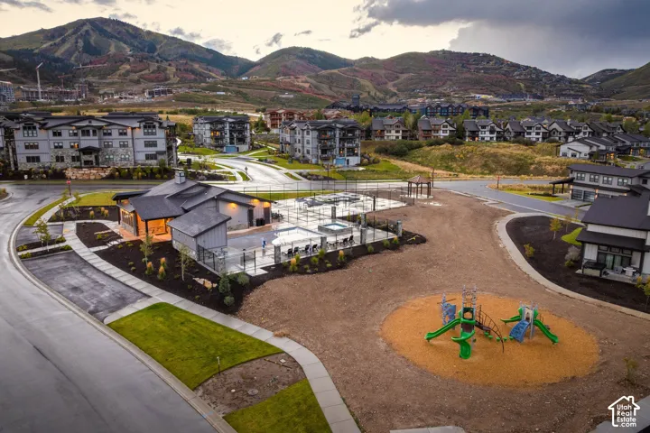 Community amenities featuring a clubhouse, pool, spa, and playground area
