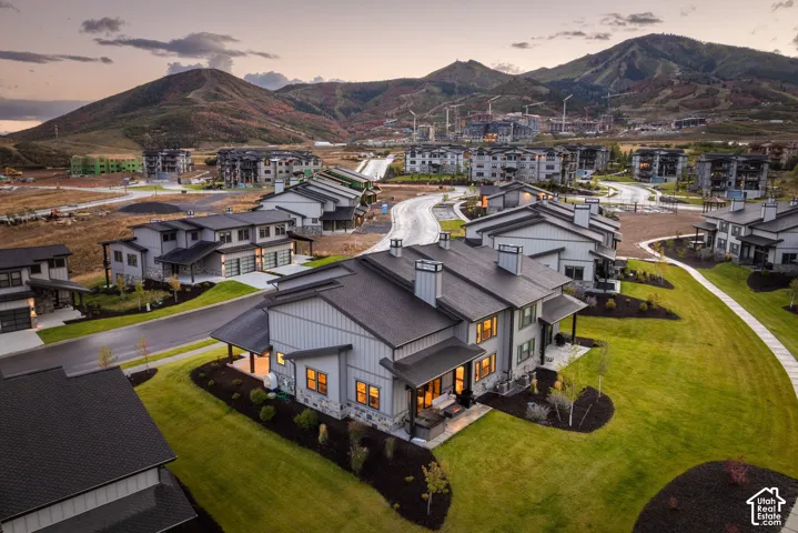 Modern architectural design with light gray siding and dark gray roofing