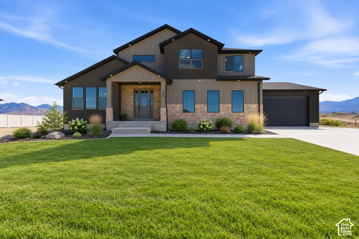 Modern exterior featuring stone and vertical siding accents