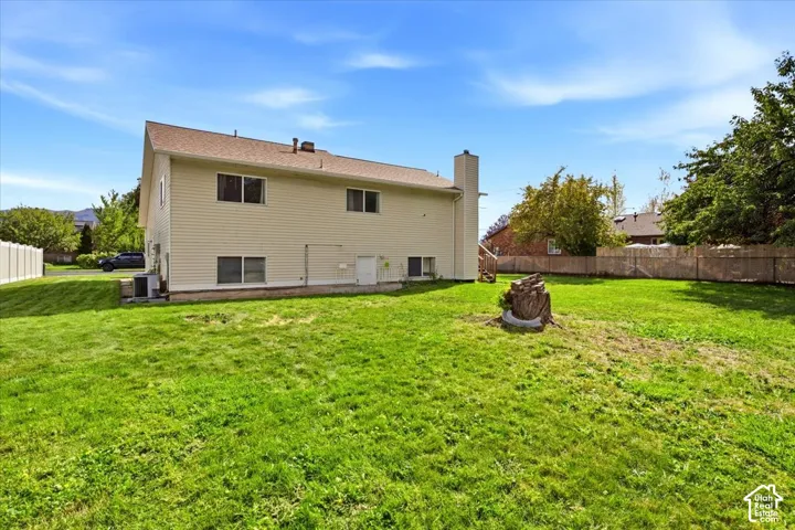 Expansive green lawn with a privacy fence