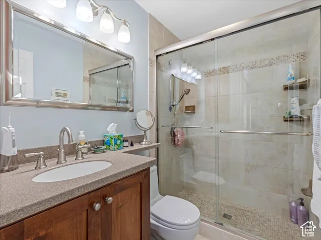 Wood-finish vanity with an integrated sink and brushed nickel faucet
