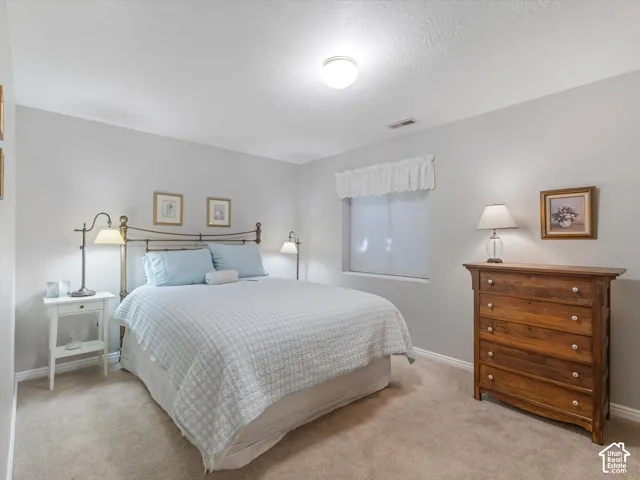 Carpeted flooring, recessed window, and overhead lighting