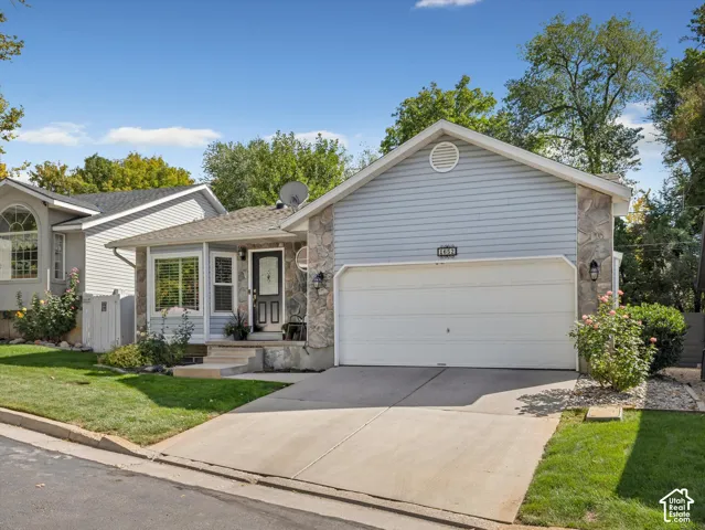 Stone veneer and siding exterior with an attached garage