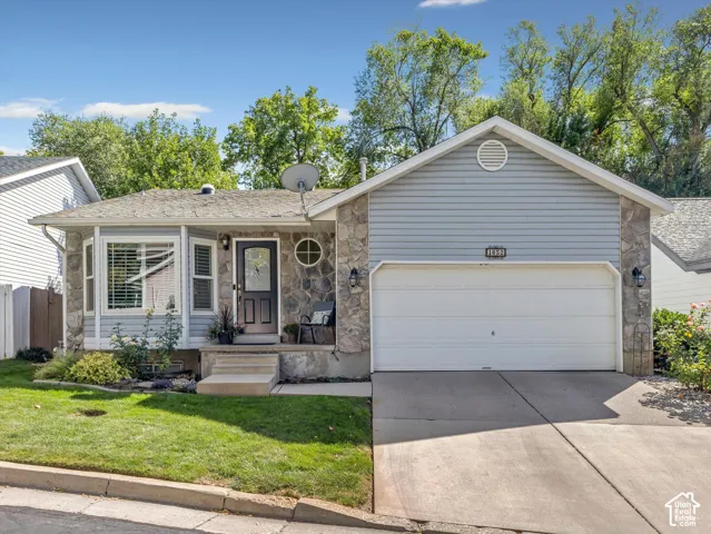 Stone veneer and siding exterior with an attached two-car garage