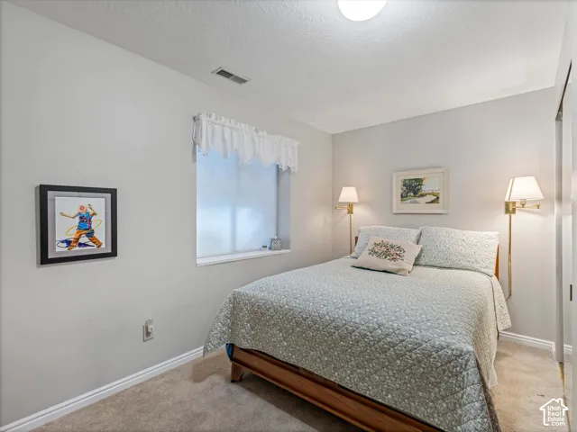 Recessed window with white trim, wall-mounted sconces, and a flush-mount ceiling light fixture