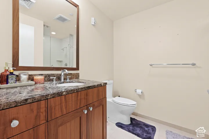 Wood-finish vanity with a stone-finish countertop and integrated sink
