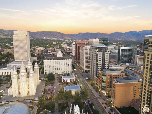 Urban setting featuring a diverse architectural landscape, mountain backdrop, and expansive city infrastructure