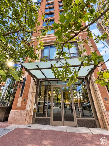 Brick facade building with a glass and metal canopy entrance