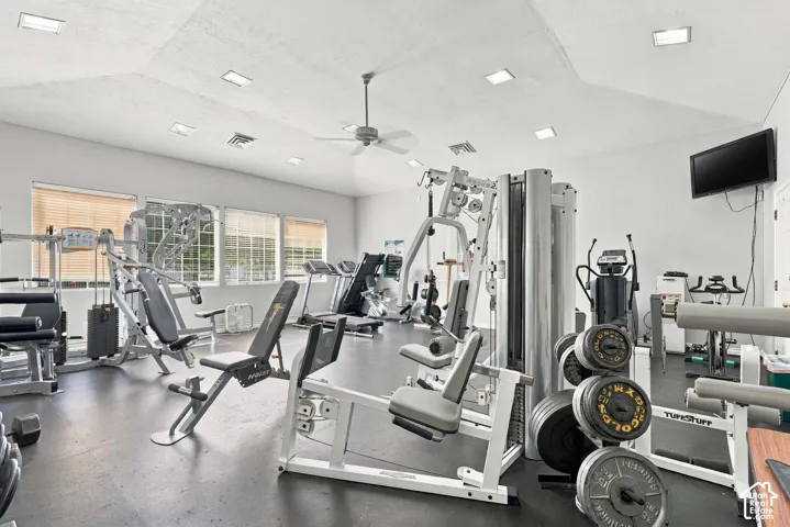 Dedicated fitness space featuring a sloped ceiling with recessed lighting, ceiling fan, and multiple windows