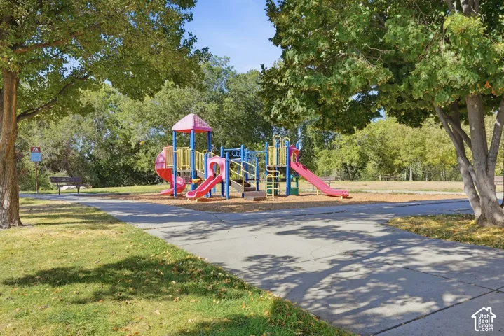 Community playground structure featuring multiple slides and climbing elements