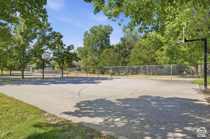 Expansive recreational court with professional-grade fencing and multiple sport line markings on durable asphalt surfacing