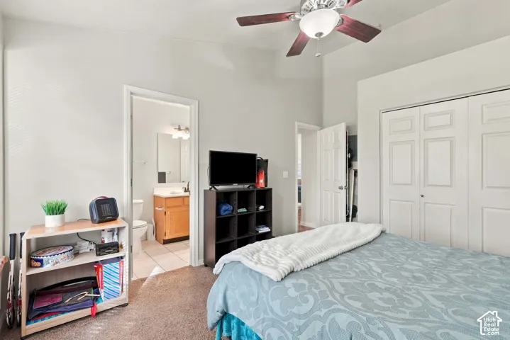 Vaulted ceilings, carpeted flooring, and a ceiling fan with integrated lighting