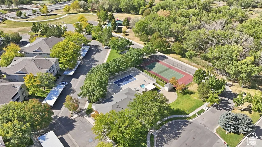 Community amenities featuring a swimming pool, spa, tennis court, and covered parking spaces