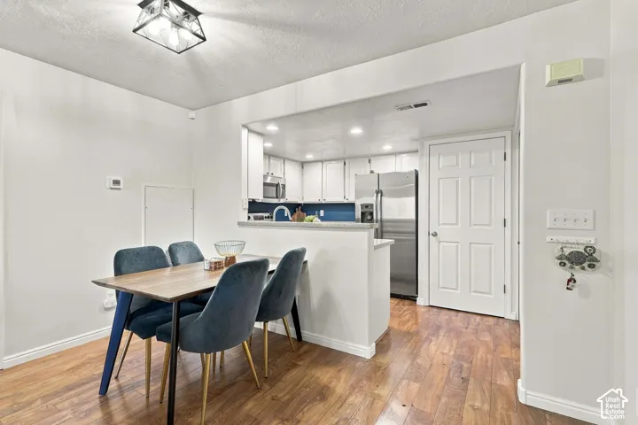 Wood-finish flooring throughout the dining area and kitchen