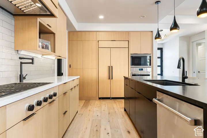 Light wood-finish cabinetry complemented by white countertops and a subway tile backsplash