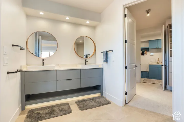 Dual rectangular vessel sinks with matte black faucets, set into a light-toned countertop