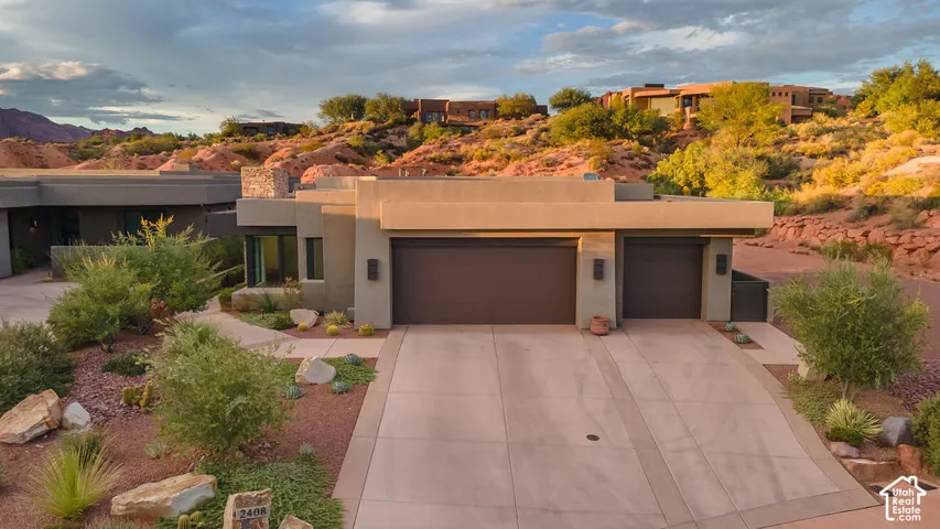 Contemporary architectural style with a two-car garage, integrated landscaping, and a concrete driveway