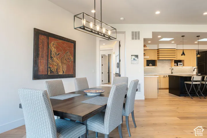 Hardwood flooring throughout, vaulted ceiling, and an open-concept layout