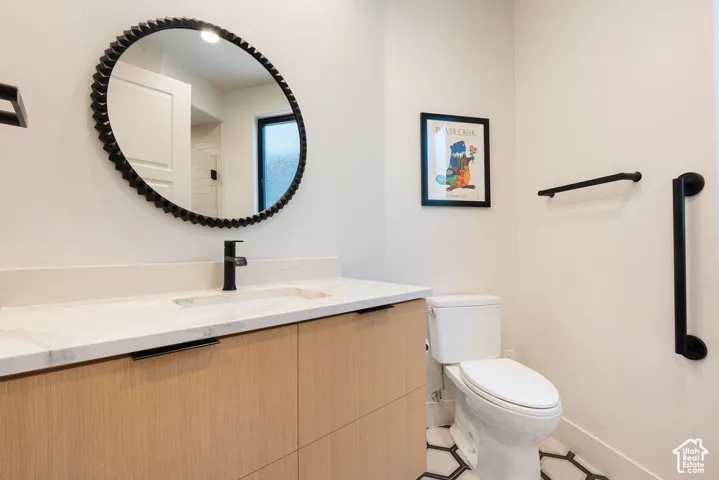 Wood-finish vanity with a light-colored countertop and integrated sink
