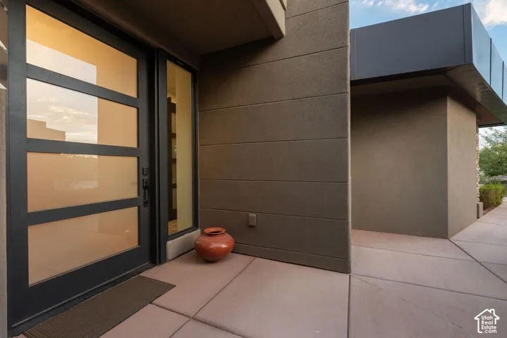 Modern entry door with multiple glass lites and a black frame, complemented by a sidelight