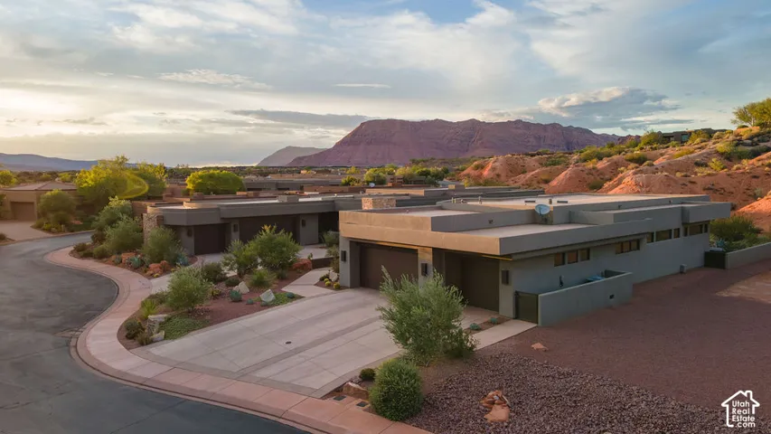 Modern architecture with a flat roofline, integrated garage, and a concrete driveway