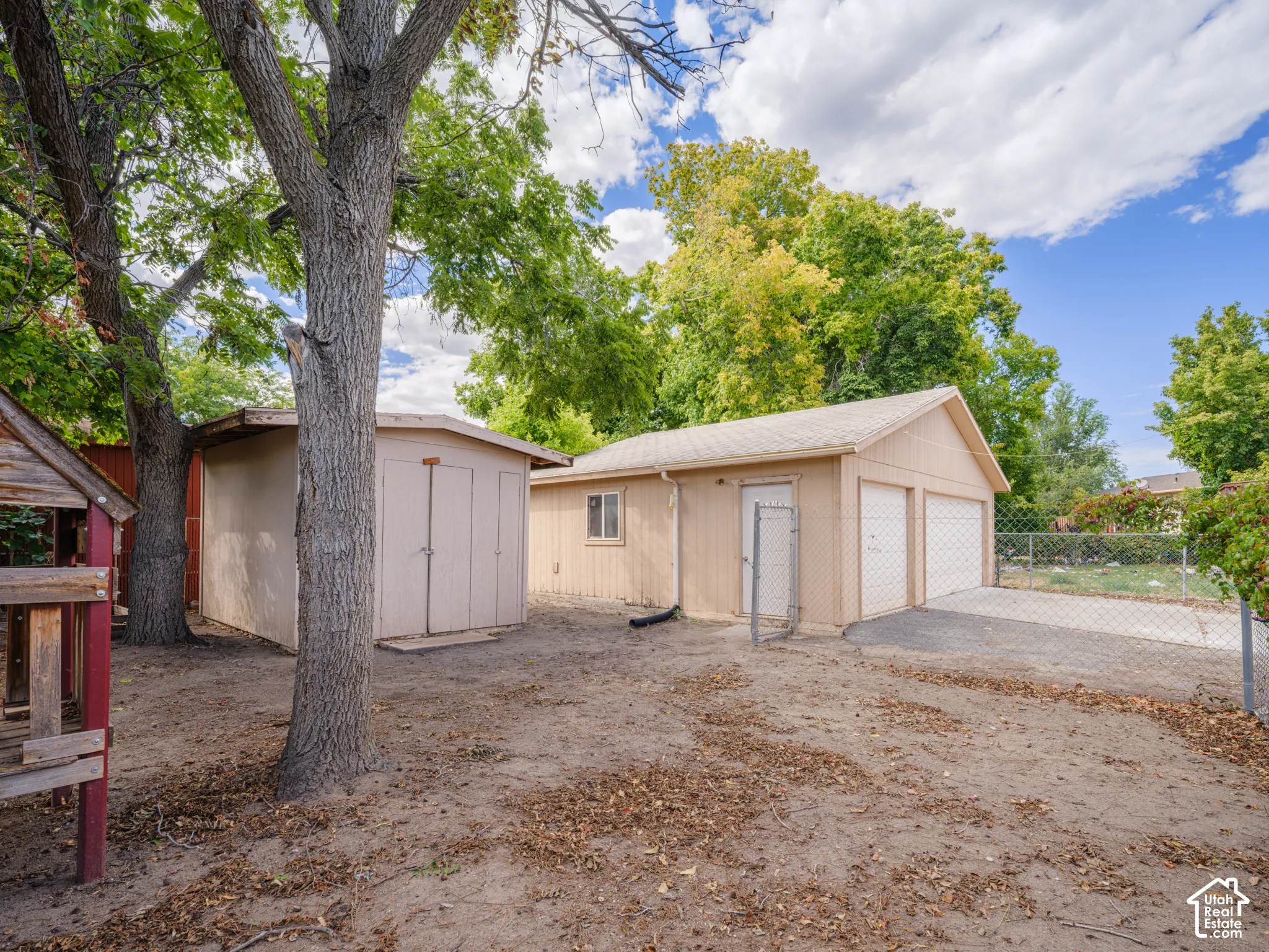 Detached three-car garage with asphalt driveway
